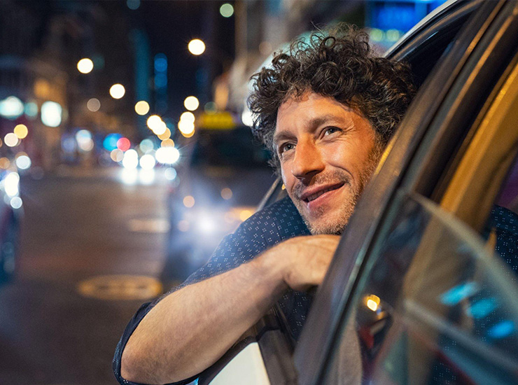 Happy man looking the city at night