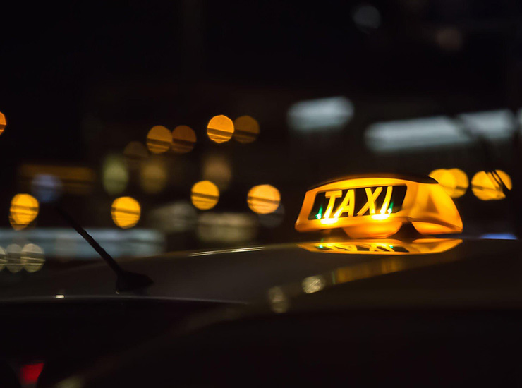 Illuminated sign taxi on the roof of the car